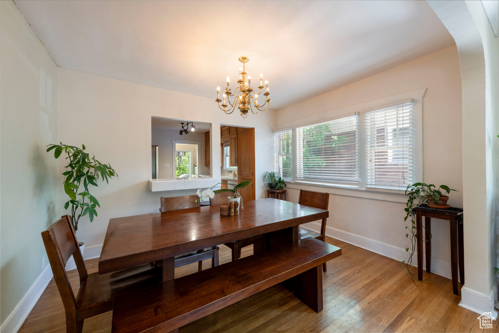 Dining space with a chandelier and light wood finished floors
