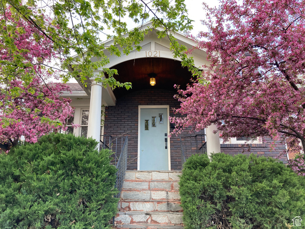 Property entrance featuring brick siding