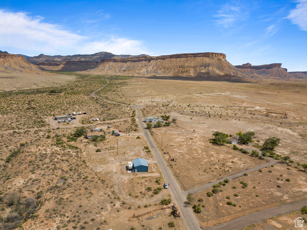 View of property location featuring mountains, a desert landscape, and rural landscape