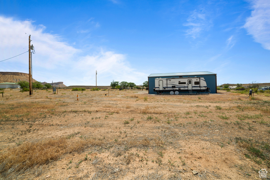 View of yard with an outdoor structure and a rural view