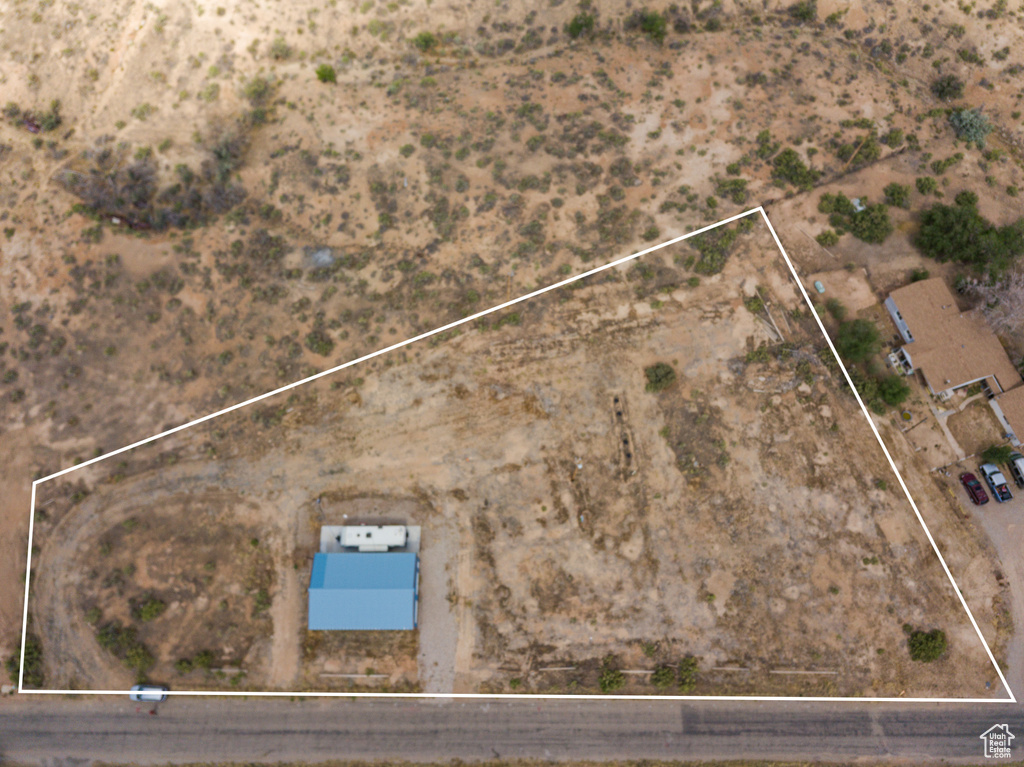 Aerial view of property and surrounding area featuring property parcel outlined
