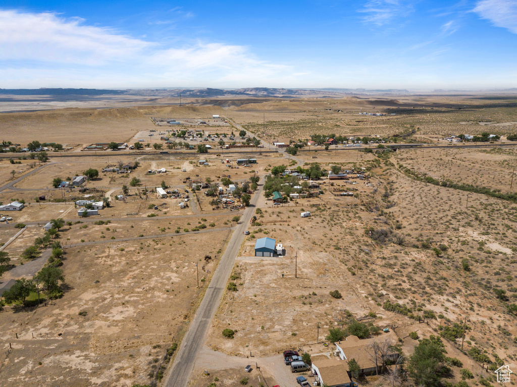 Aerial view of property and surrounding area with rural landscape, a desert landscape, and a mountain backdrop