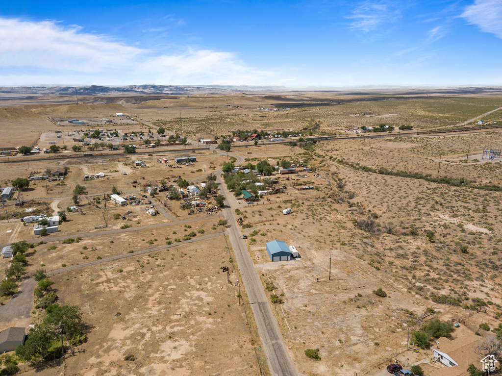 Aerial view of property and surrounding area featuring rural landscape, a desert landscape, and mountains
