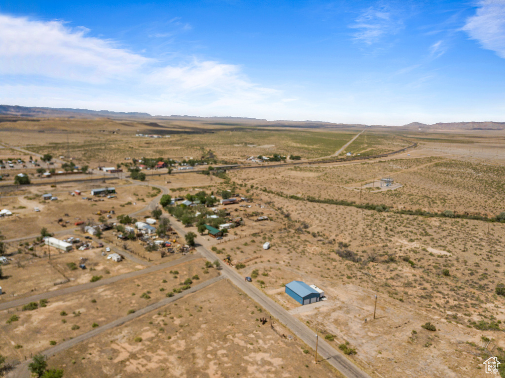 View of rural area with a desert landscape and a mountainous background