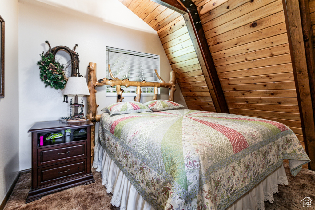 Carpeted bedroom featuring wooden ceiling and lofted ceiling