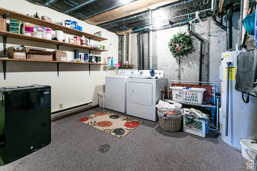Laundry area featuring a baseboard heating unit, water heater, washer and clothes dryer, and carpet floors