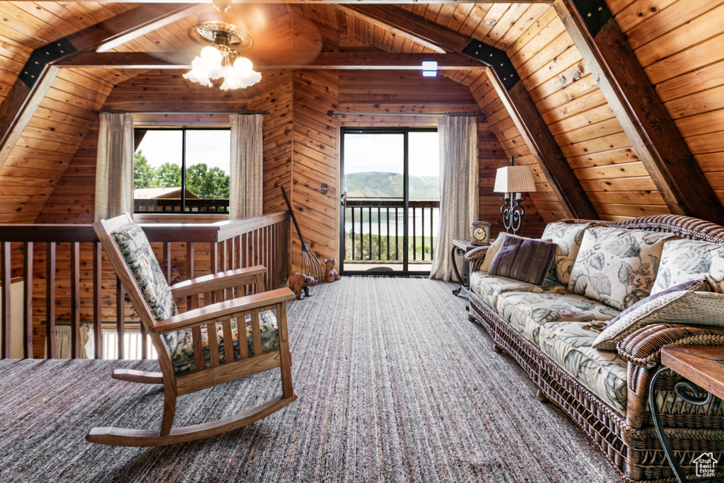 Carpeted living room with wooden ceiling and wood walls