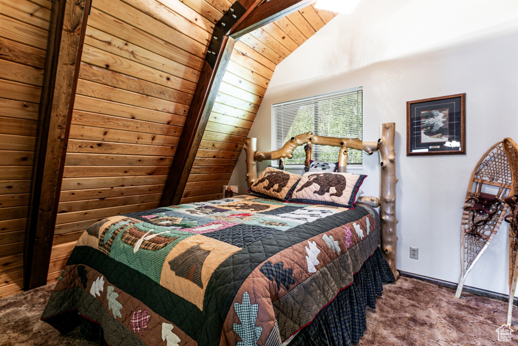 Carpeted bedroom with lofted ceiling and baseboards