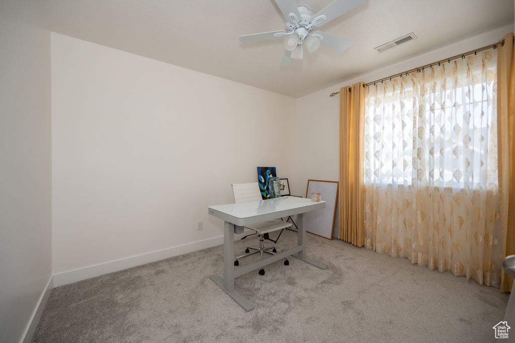 Office area featuring carpet and ceiling fan