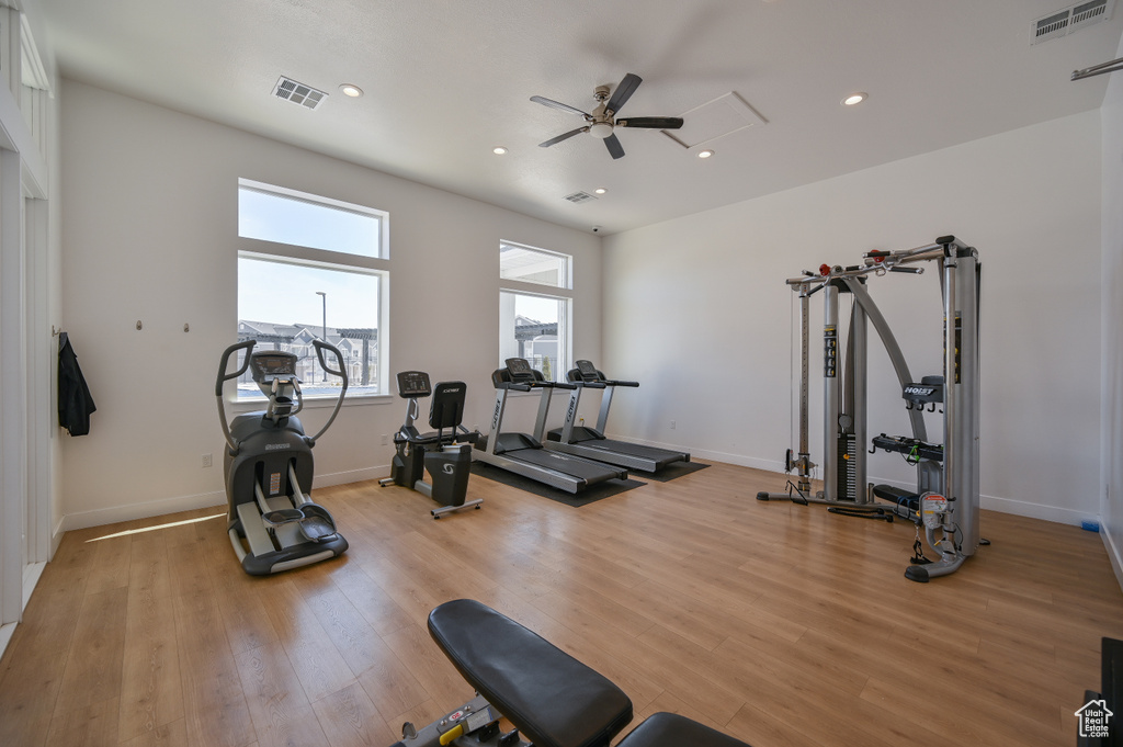 Exercise area with a ceiling fan, light wood-style floors, and recessed lighting