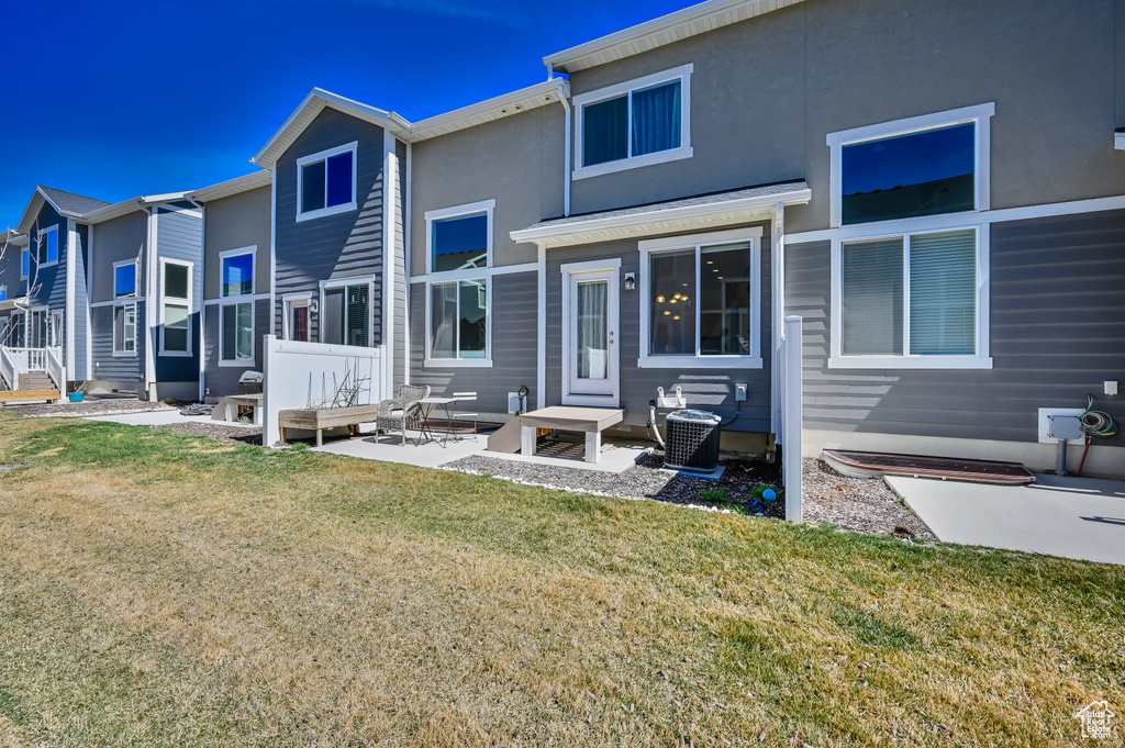 Back of house with a lawn, a patio, and outdoor lounge area
