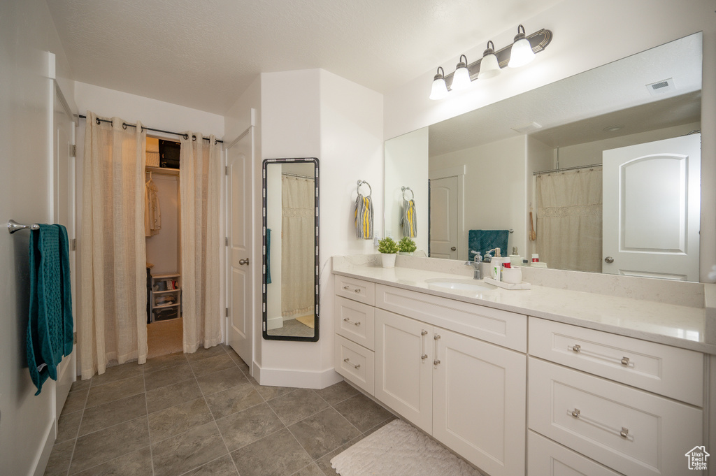 Full bathroom featuring baseboards and vanity