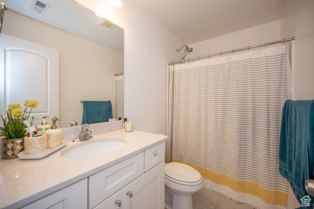 Bathroom featuring vanity, tile patterned flooring, and a shower with curtain