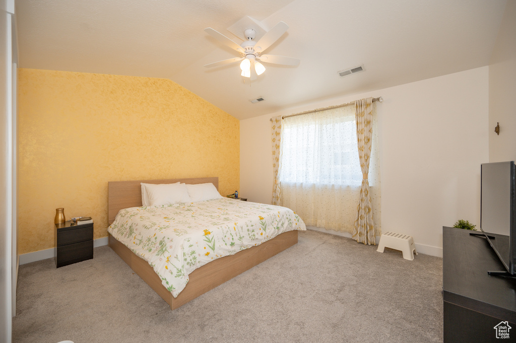 Bedroom featuring vaulted ceiling, carpet, and a ceiling fan