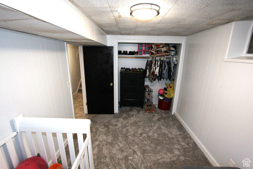 Bedroom featuring carpet flooring and a closet