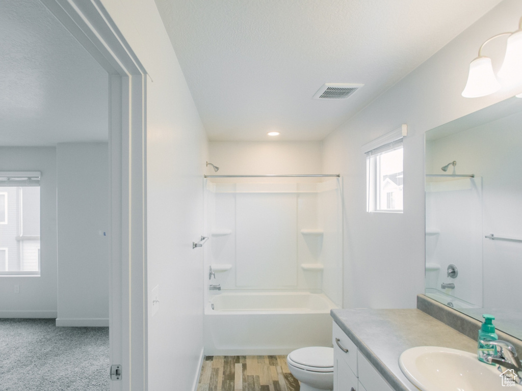 Full bathroom featuring vanity, shower / tub combination, and wood finished floors