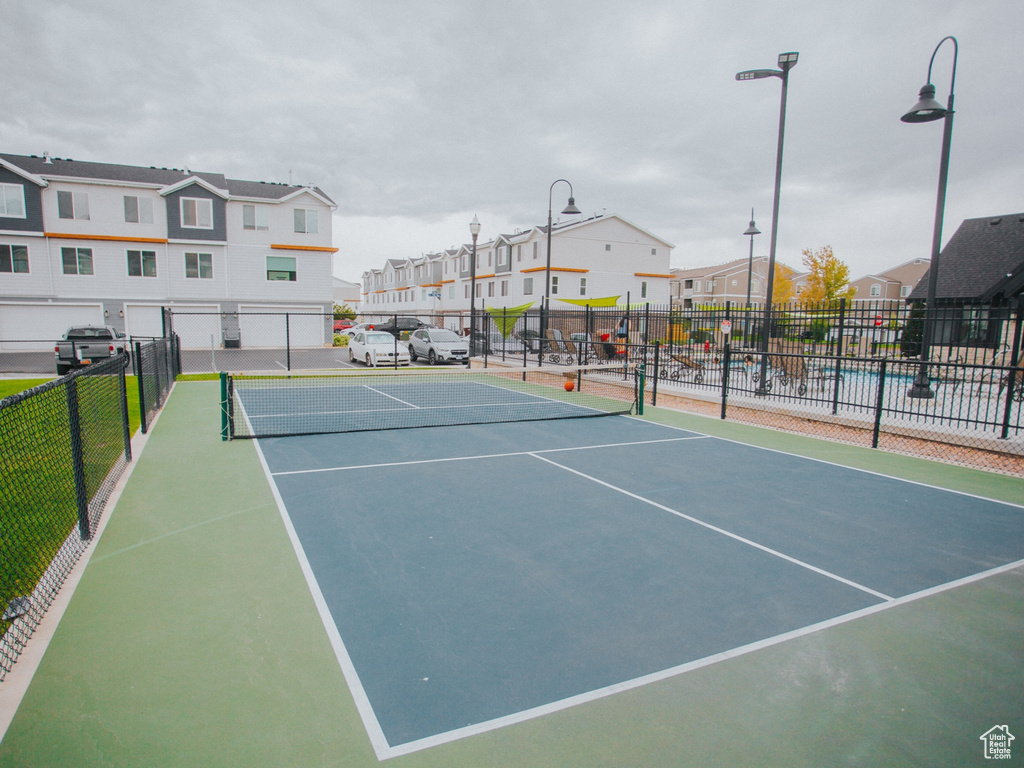 View of tennis court featuring a residential view