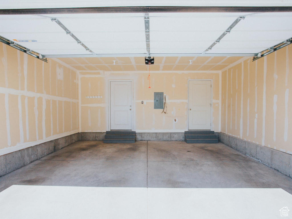 Garage with electric panel and a garage door opener