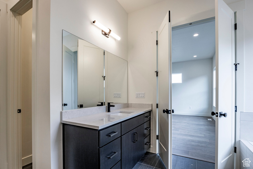 Bathroom with vanity and recessed lighting