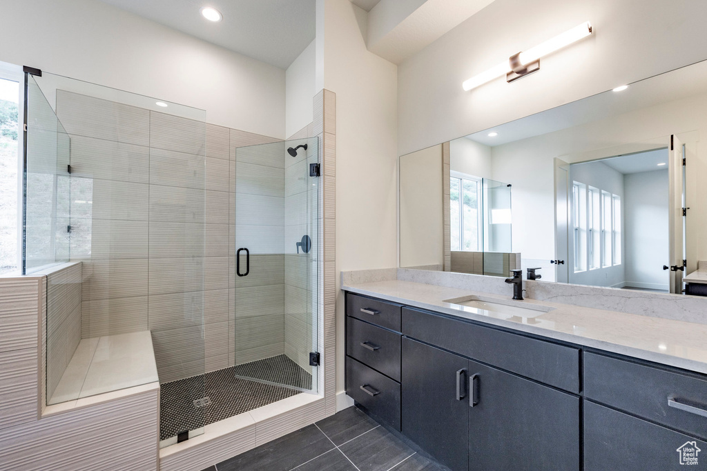 Bathroom with a stall shower, vanity, recessed lighting, and tile patterned flooring