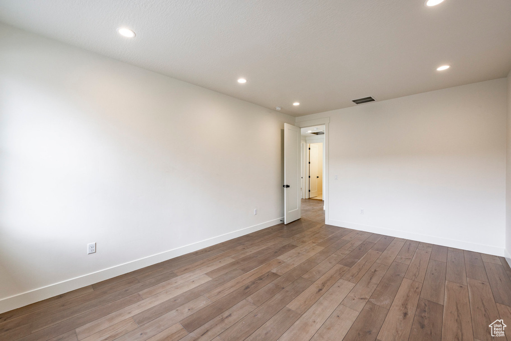 Unfurnished room with recessed lighting and wood-type flooring
