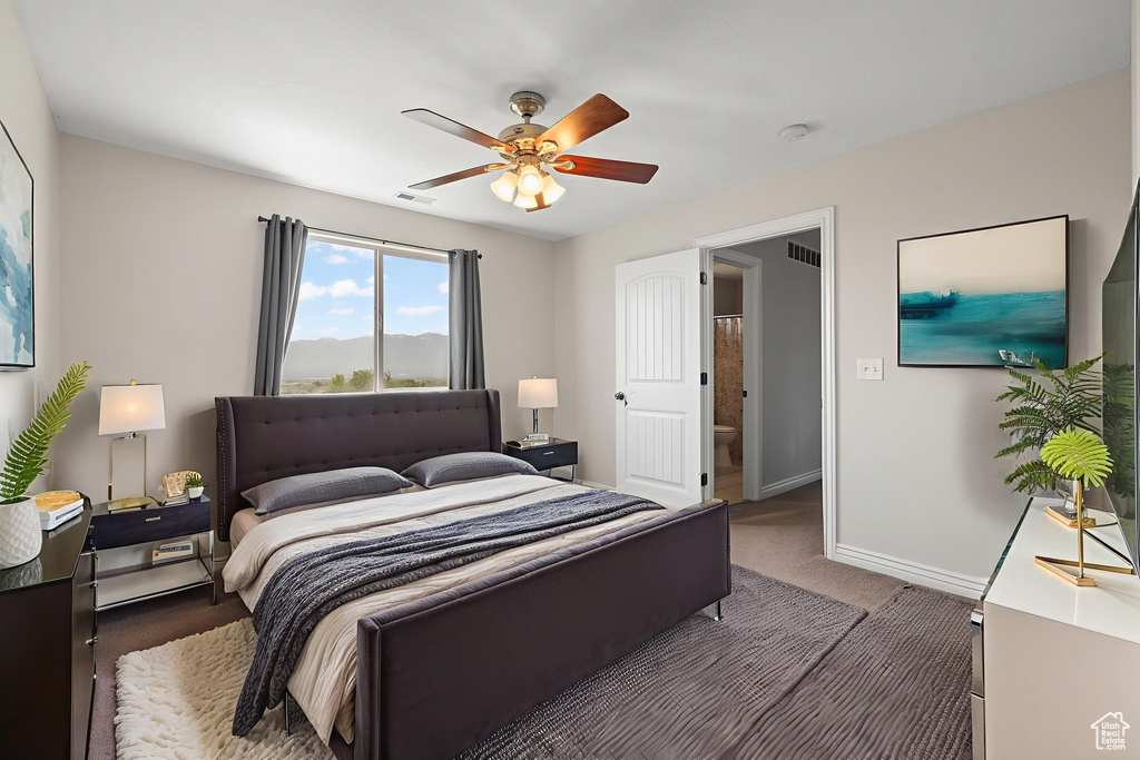 Carpeted bedroom featuring baseboards and a ceiling fan