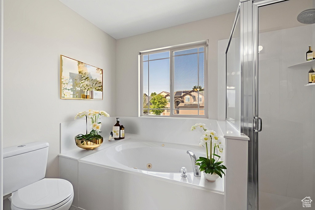 Full bath featuring a whirlpool tub and a shower stall