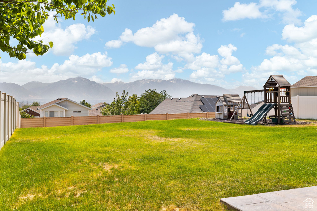 View of yard with a playground and a mountain view