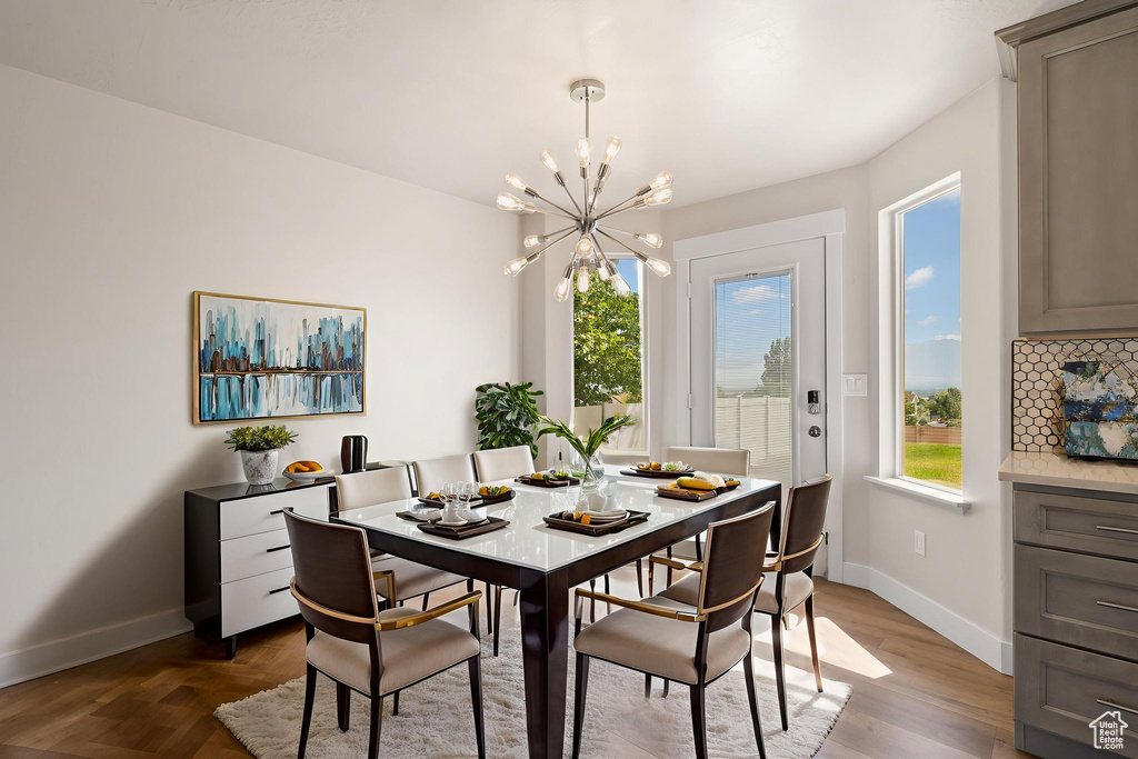 Dining room featuring baseboards and a chandelier