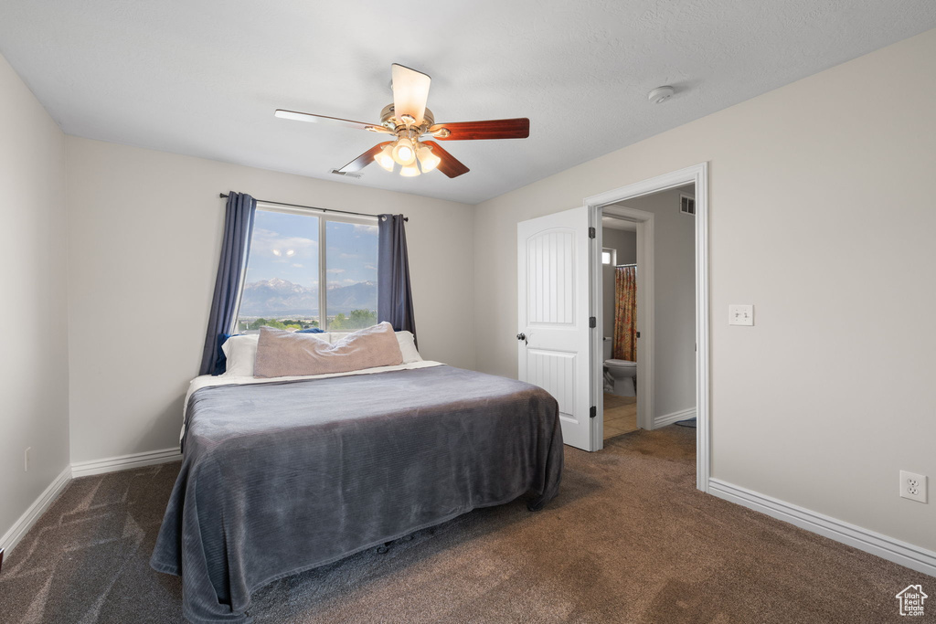 Carpeted bedroom featuring baseboards and a ceiling fan