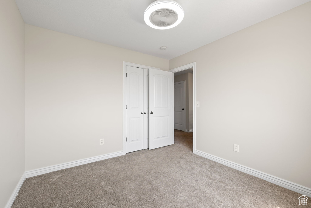 Unfurnished bedroom with carpet floors and a closet
