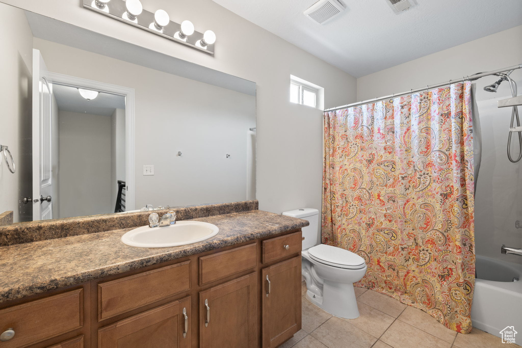 Full bath featuring vanity, tile patterned flooring, and shower / bath combo