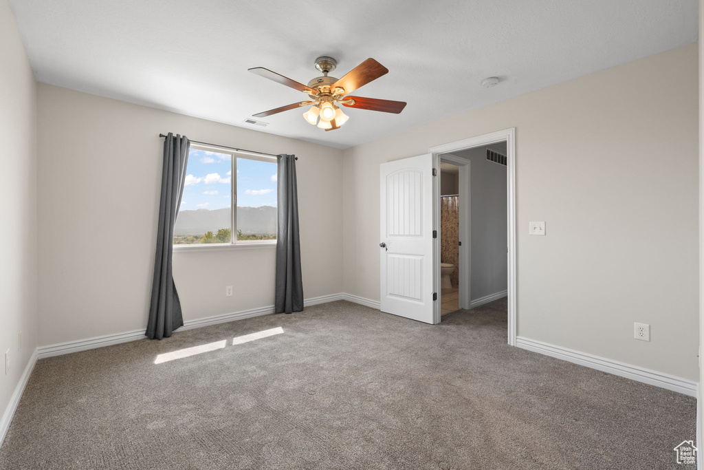 Unfurnished bedroom with carpet flooring and ceiling fan