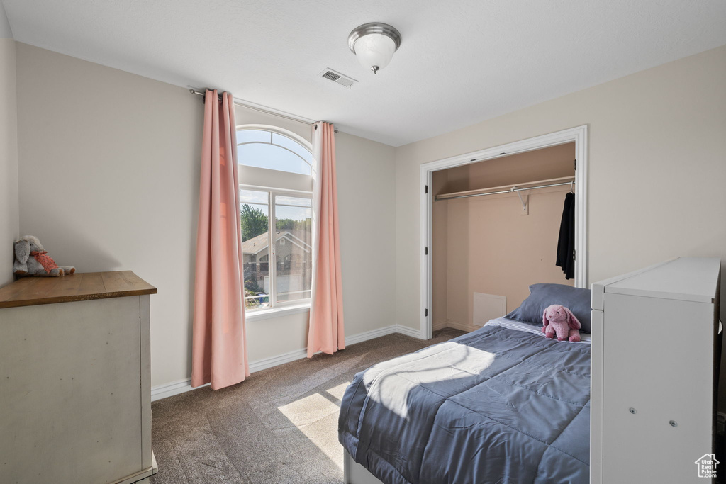 Carpeted bedroom with baseboards