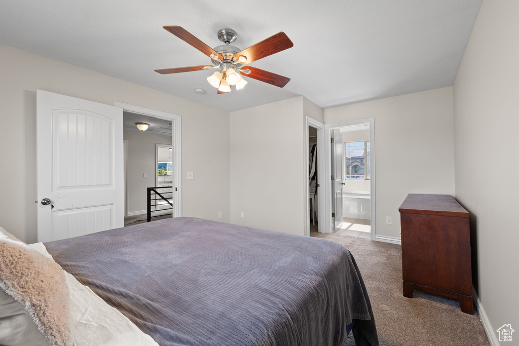 Bedroom featuring carpet, ensuite bath, and ceiling fan