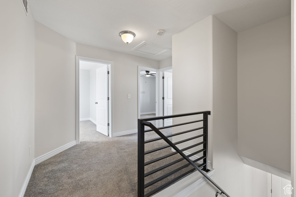 Hall with an upstairs landing and carpet