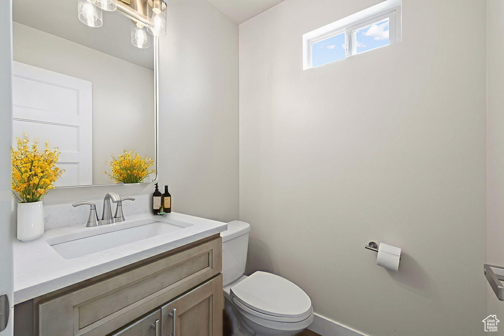 Half bathroom with toilet and vanity
