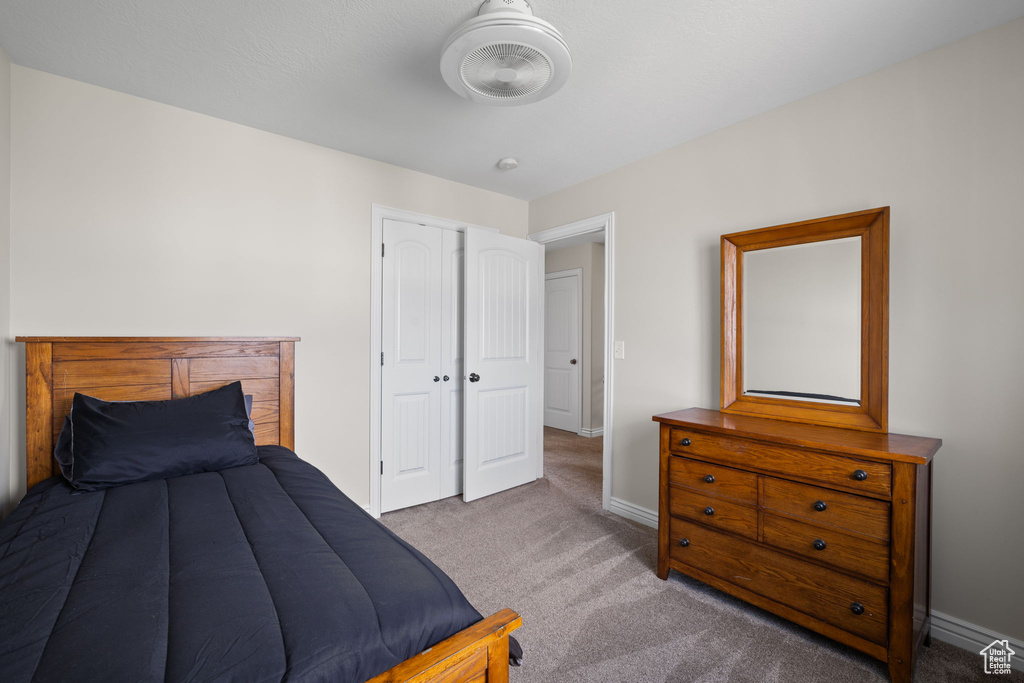 Bedroom featuring carpet flooring and a closet