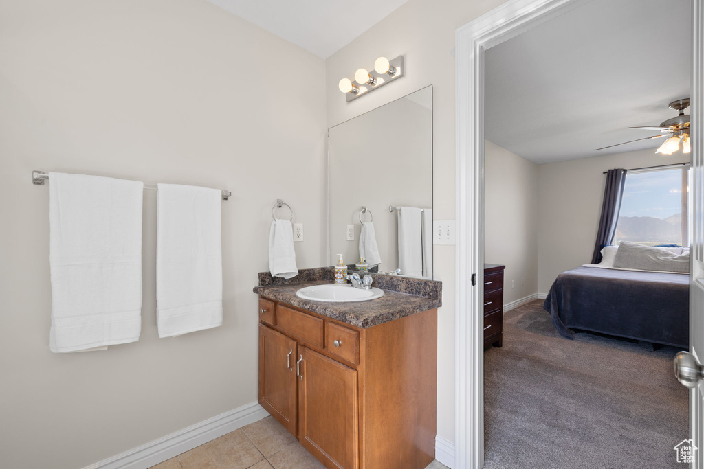 Bathroom with vanity, ensuite bathroom, a ceiling fan, and tile patterned flooring