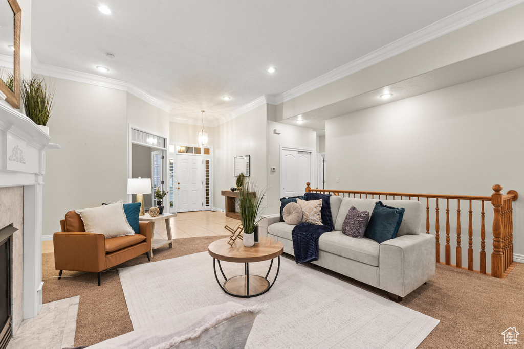 Carpeted living room with recessed lighting, ornamental molding, and a premium fireplace
