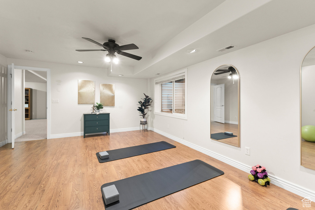 Workout room featuring arched walkways, a ceiling fan, wood finished floors, and recessed lighting