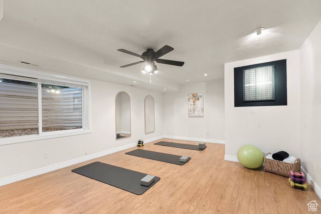 Workout room with wood finished floors, ceiling fan, and recessed lighting