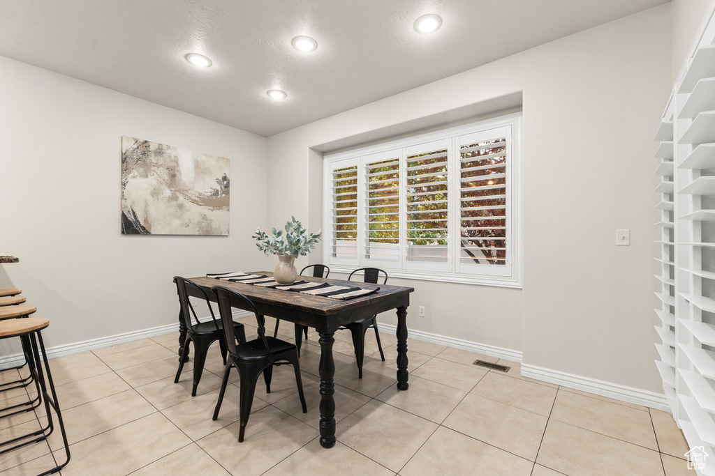 Dining space featuring recessed lighting and light tile patterned floors