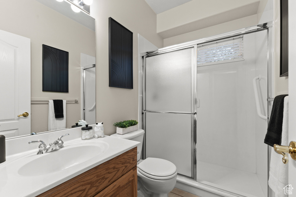 Bathroom with a shower stall and vanity
