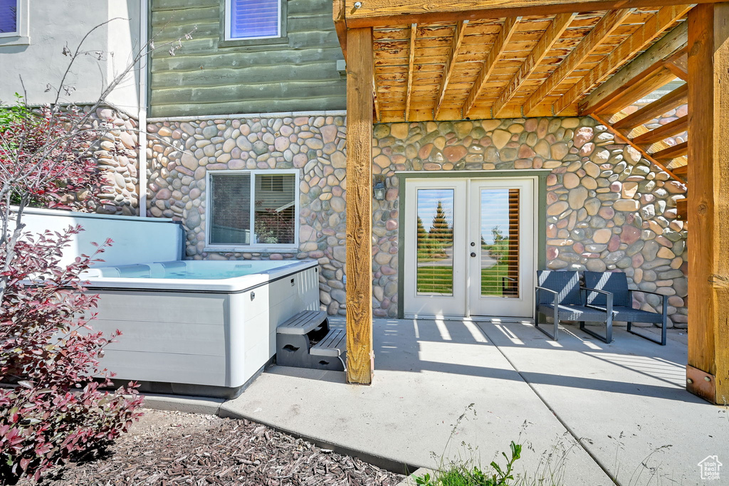 View of patio / terrace with a hot tub and french doors