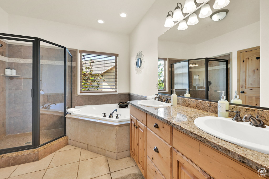Full bath with double vanity, a stall shower, a garden tub, tile patterned flooring, and recessed lighting