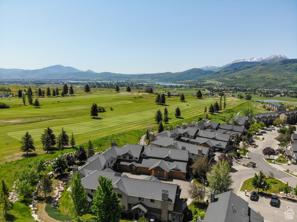 Aerial view of a mountainous background and a golf club