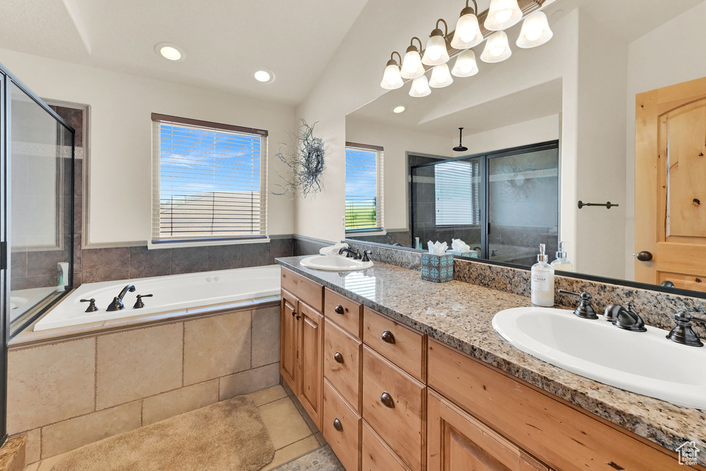Bathroom featuring a shower stall, double vanity, tile patterned flooring, a bath, and recessed lighting