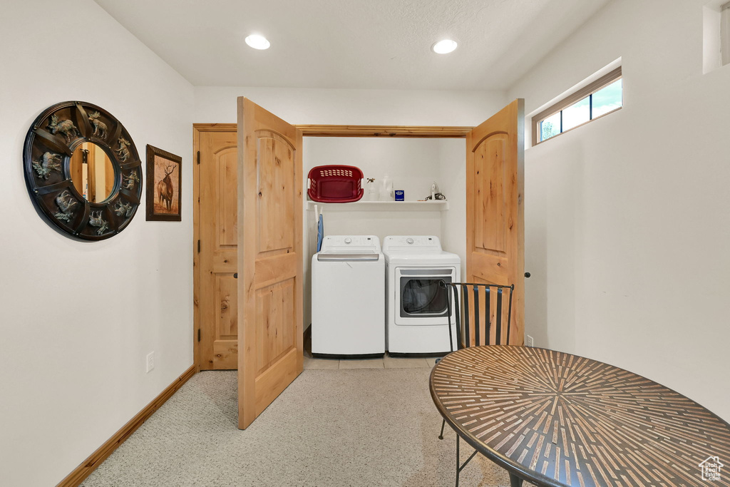 Washroom featuring washing machine and dryer, recessed lighting, and light colored carpet
