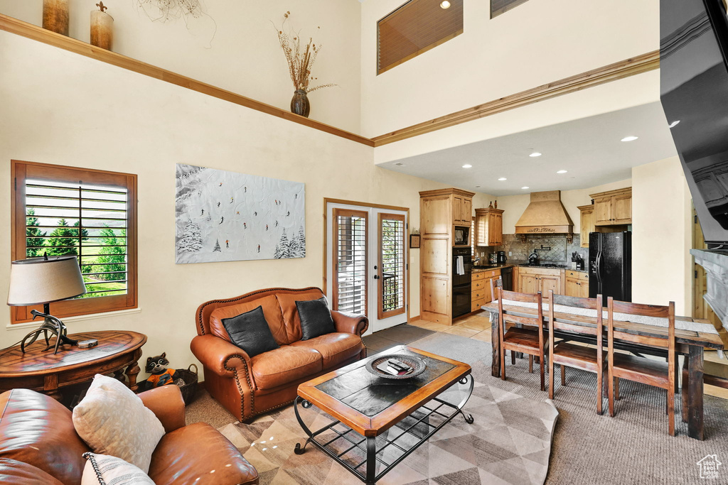 Living room featuring a towering ceiling and recessed lighting